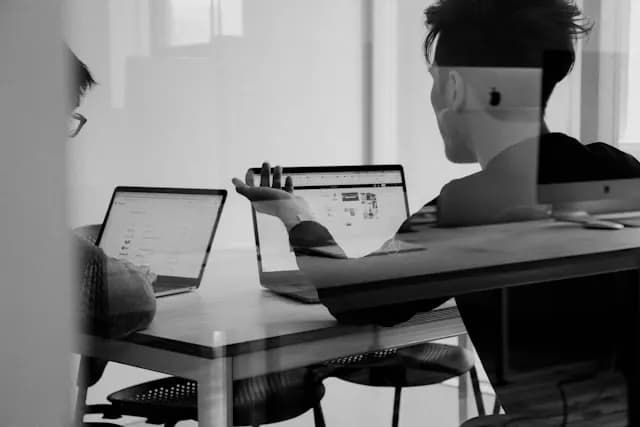 Two employees working with computers